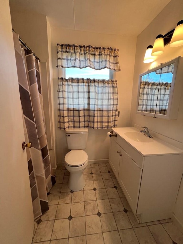 bathroom featuring vanity, toilet, and plenty of natural light