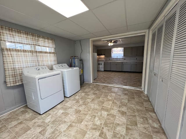 laundry area with sink, electric water heater, washer and clothes dryer, and ceiling fan