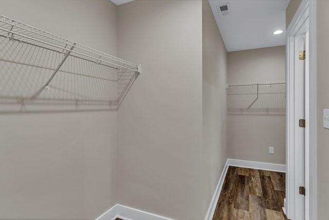 walk in closet featuring visible vents and wood finished floors