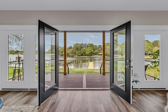 entryway with a water view, french doors, and wood finished floors