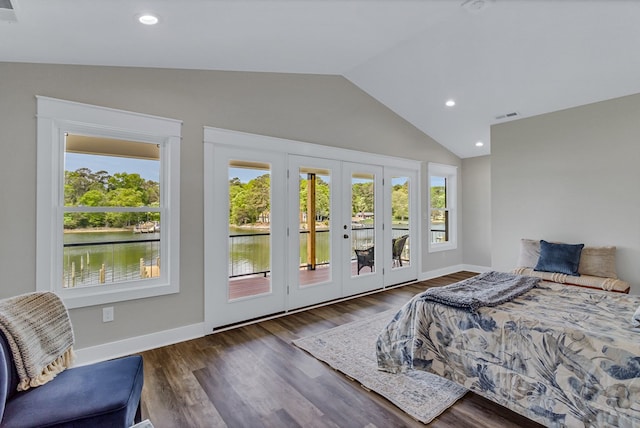 bedroom featuring access to exterior, french doors, lofted ceiling, and wood finished floors