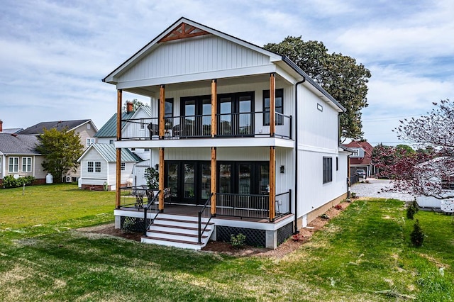 back of house with a yard and a balcony