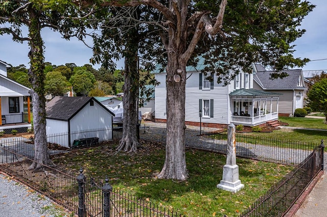 view of front of house with a fenced backyard and a front yard