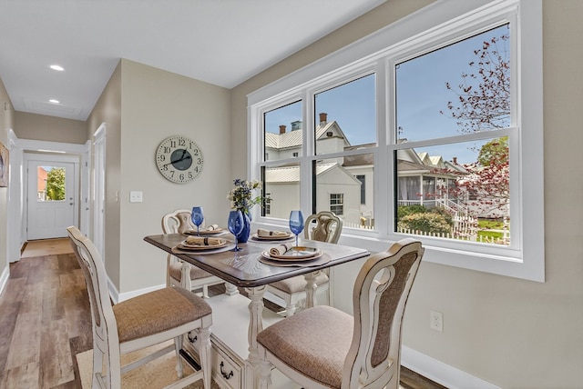 dining area featuring baseboards, recessed lighting, and wood finished floors