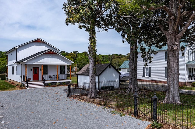 bungalow-style home featuring a porch and fence