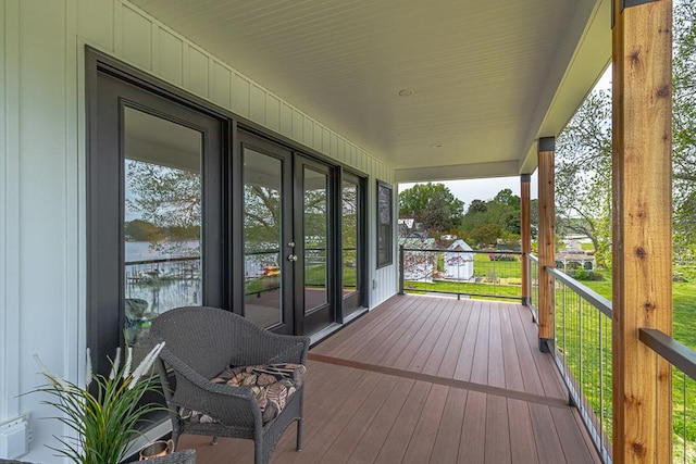 deck with a water view and french doors