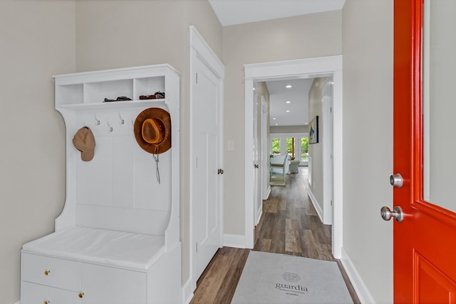 mudroom featuring recessed lighting, dark wood-style flooring, and baseboards