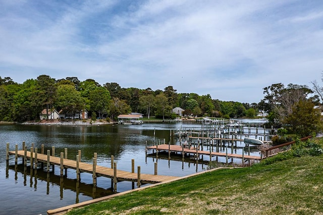 dock area featuring a lawn and a water view