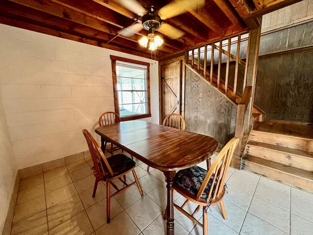 59 Judith Sound Cir, Lottsburg, VA 22511 - dining space featuring ceiling fan, stairway, tile patterned flooring, and concrete block wall