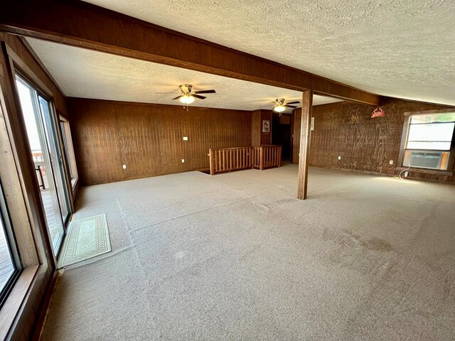 59 Judith Sound Cir, Lottsburg, VA 22511 - unfurnished living room with a textured ceiling, cooling unit, wooden walls, ceiling fan, and carpet