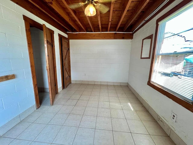 59 Judith Sound Cir, Lottsburg, VA 22511 - spare room with concrete block wall, plenty of natural light, and light tile patterned floors
