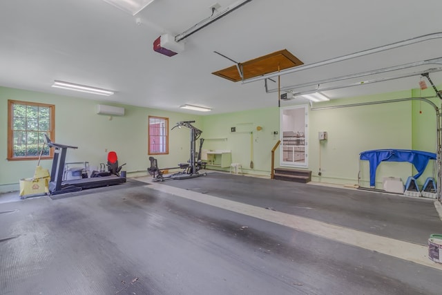 garage with a garage door opener and a wall mounted AC