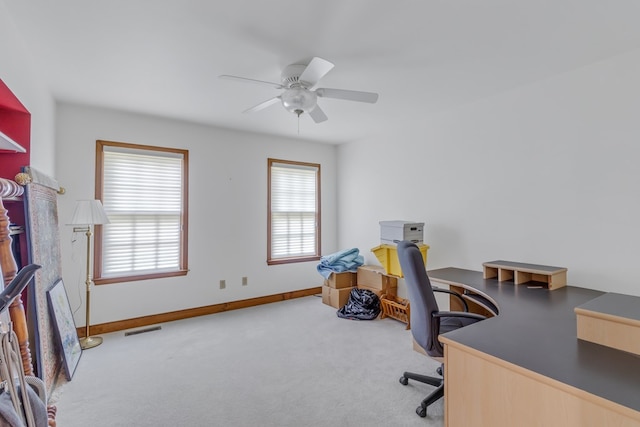 carpeted office space featuring ceiling fan