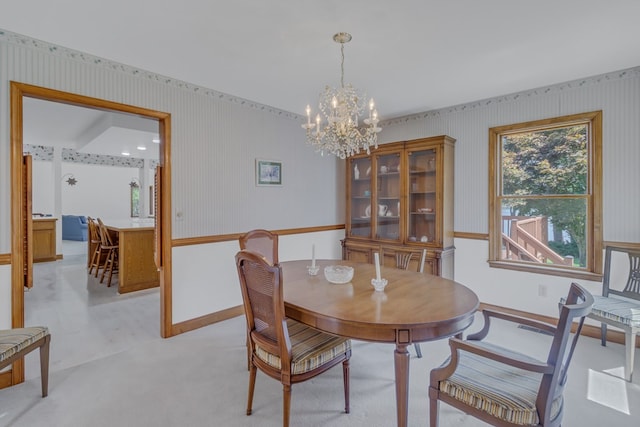 dining area featuring an inviting chandelier