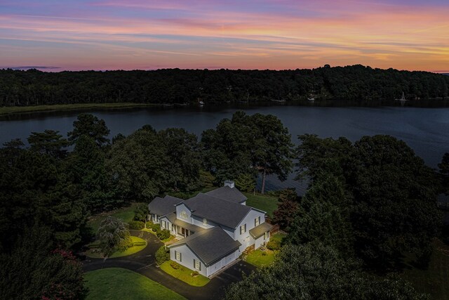 aerial view at dusk with a water view