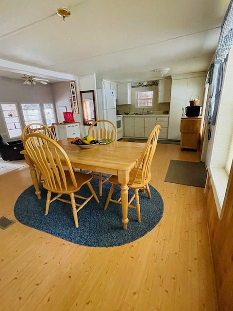 dining space with visible vents and light wood-style floors