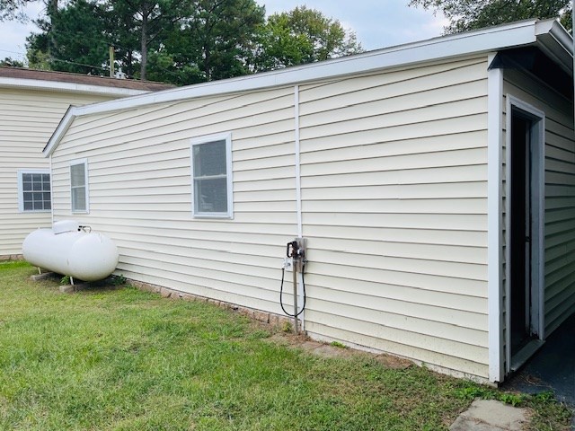 view of property exterior with a yard