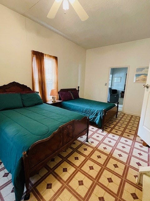 bedroom with ceiling fan, light floors, and lofted ceiling