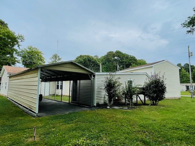 view of parking / parking lot featuring a carport and driveway