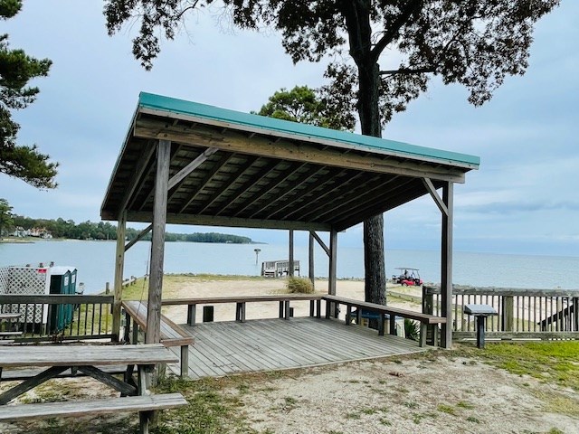 view of dock with a deck with water view