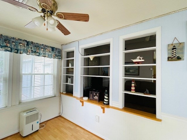 interior space with a ceiling fan and wood finished floors