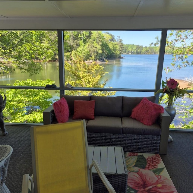 sunroom / solarium featuring a water view