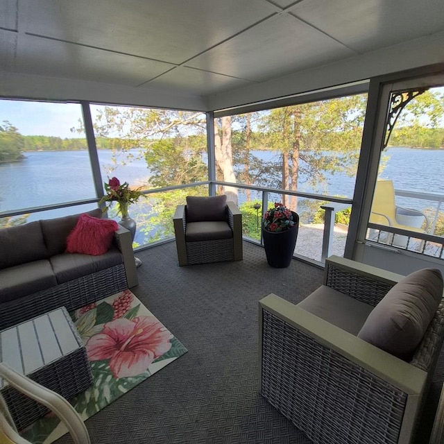 sunroom / solarium with a water view and carpet floors