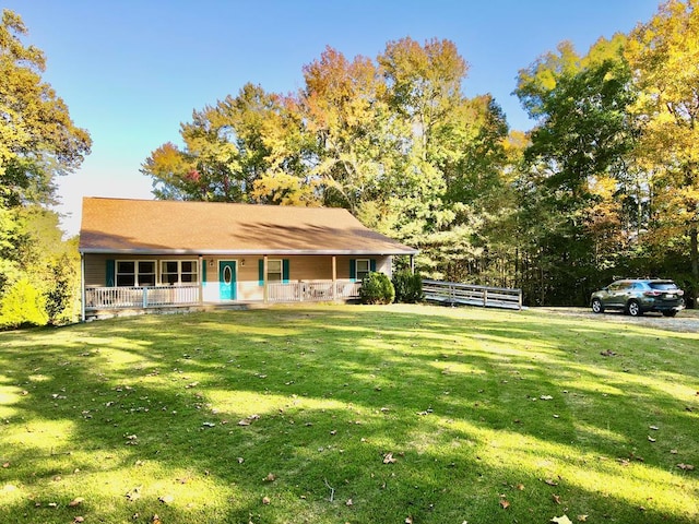 view of front of house with covered porch and a front yard