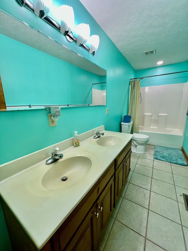 full bathroom with vanity, shower / bath combo, a textured ceiling, and toilet