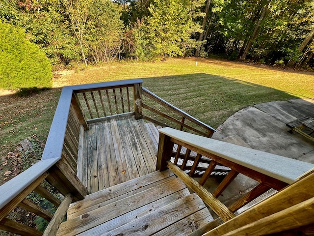 wooden terrace featuring a lawn