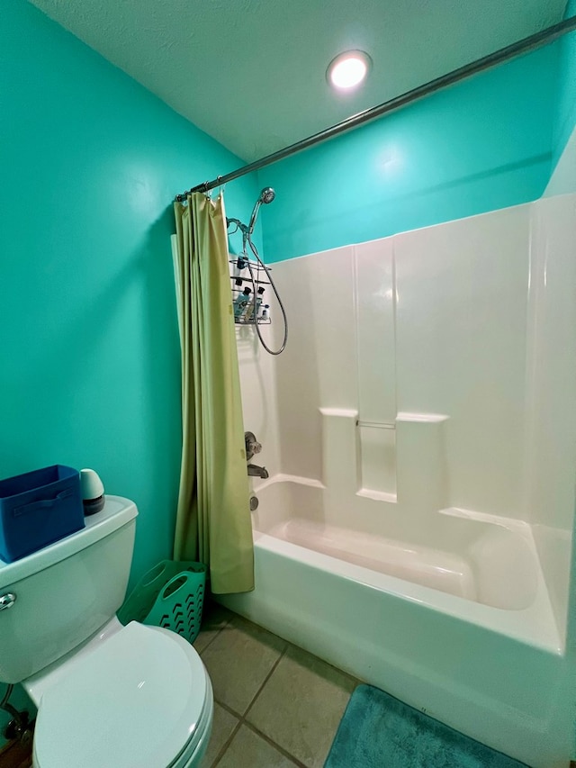 bathroom with tile patterned floors, toilet, and shower / bath combo with shower curtain