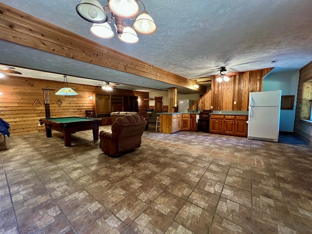 game room with ceiling fan, beamed ceiling, billiards, wood walls, and a textured ceiling