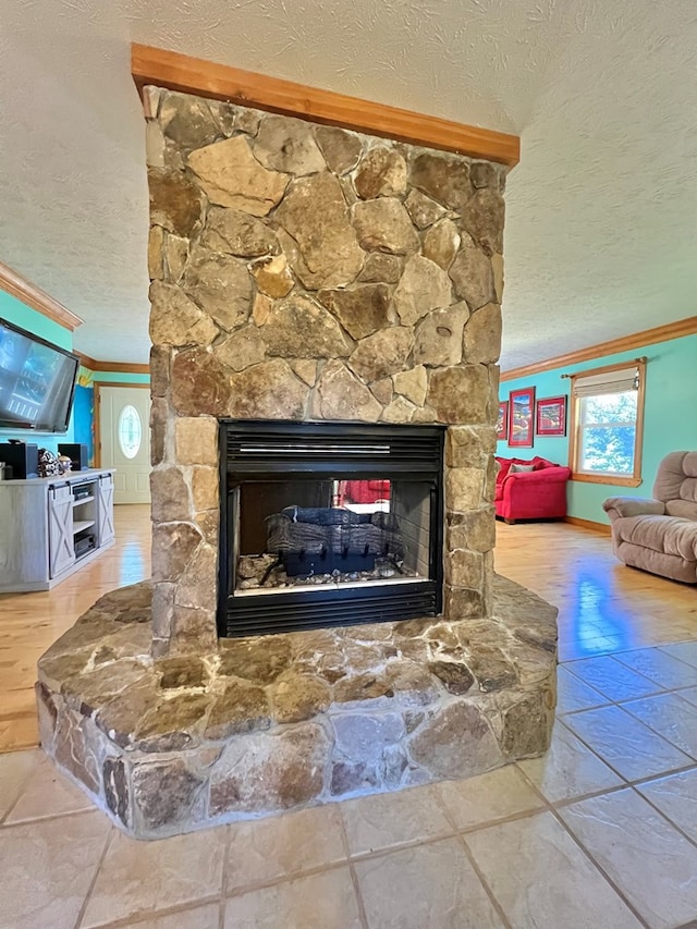 room details with crown molding, a stone fireplace, and a textured ceiling