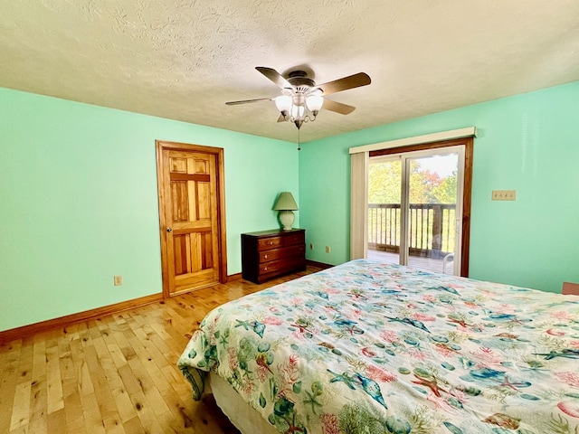 bedroom featuring access to exterior, ceiling fan, light hardwood / wood-style flooring, and a textured ceiling