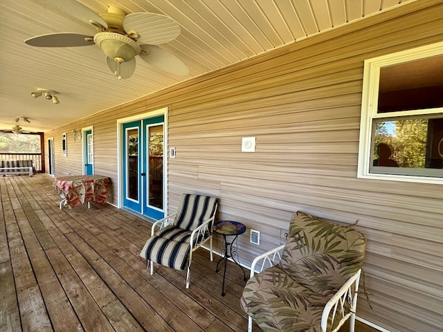 wooden deck featuring ceiling fan, a porch, and french doors