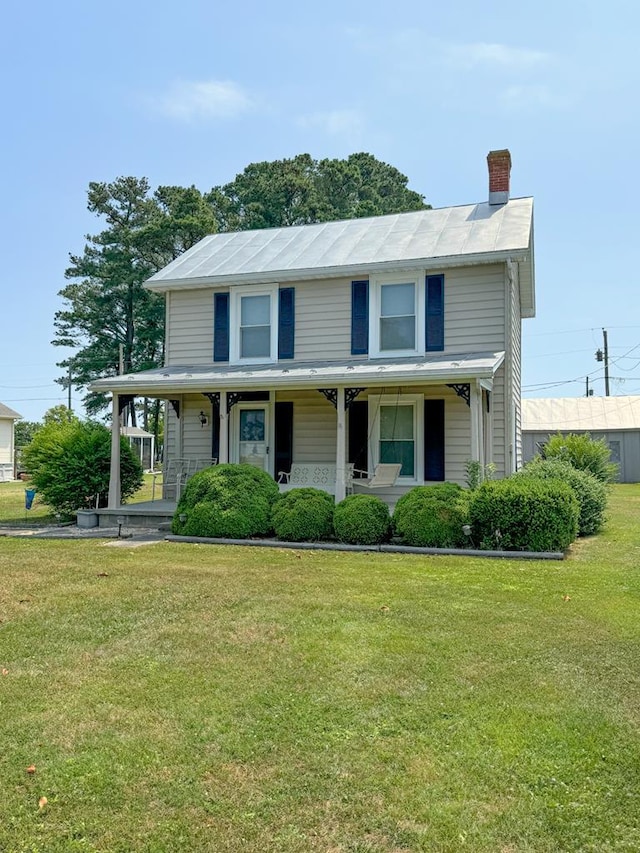 view of front of house featuring a front lawn and covered porch