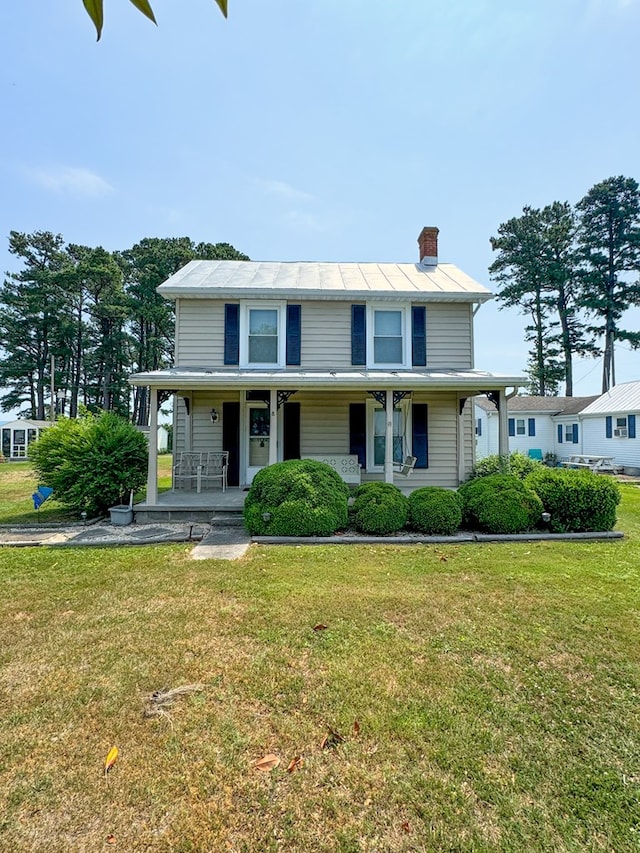 view of front of home featuring covered porch and a front yard