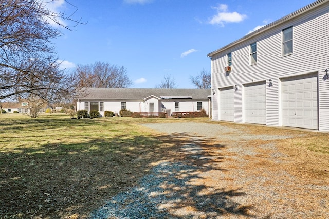 view of front of property featuring a garage, driveway, and a front lawn