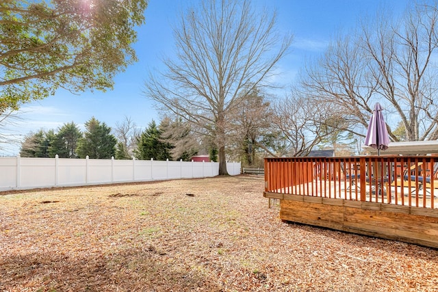 view of yard featuring a fenced backyard and a deck