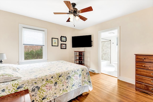 bedroom featuring visible vents, baseboards, connected bathroom, ceiling fan, and light wood-type flooring