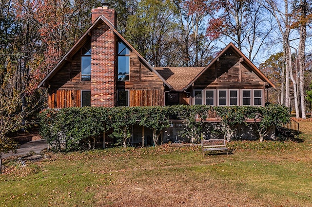 rear view of house featuring a yard