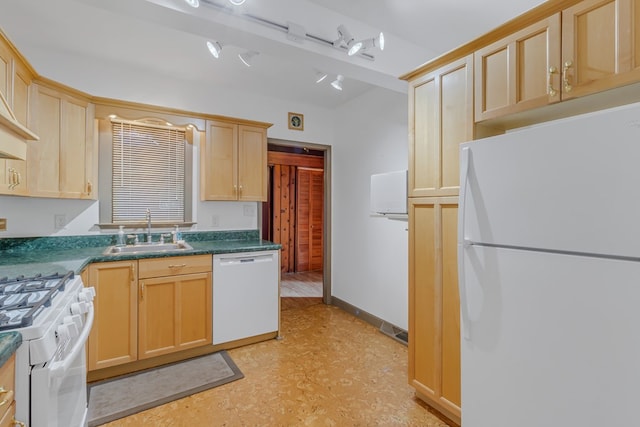 kitchen with light brown cabinetry, white appliances, and sink