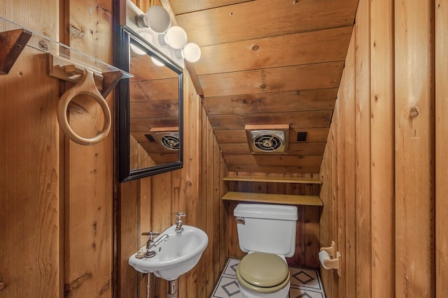 bathroom with sink, wood walls, vaulted ceiling, toilet, and wood ceiling