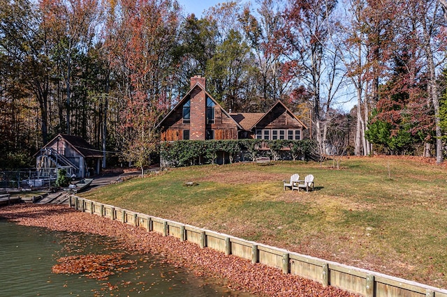 exterior space featuring a front lawn and a water view