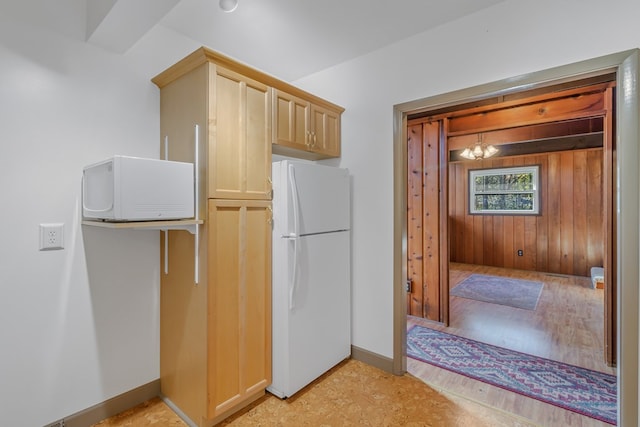 kitchen featuring light brown cabinets and white refrigerator