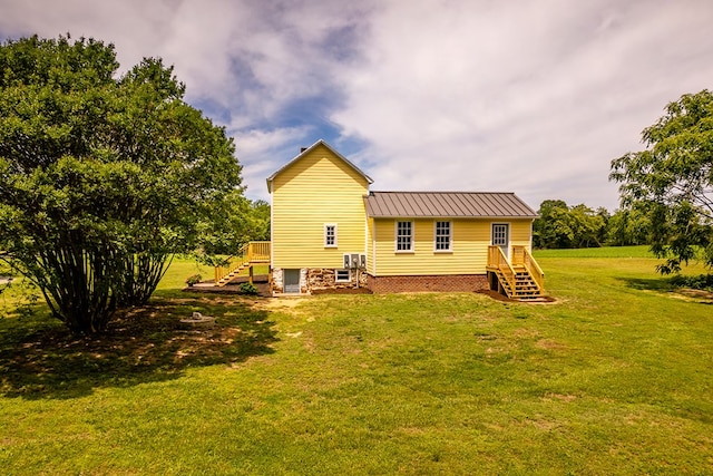 2274 Menokin Rd, Warsaw, VA 22572 - back of property with a standing seam roof, a lawn, stairs, and metal roof