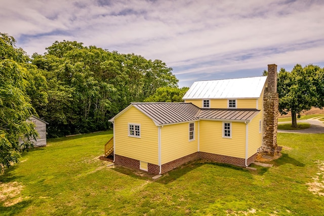 2274 Menokin Rd, Warsaw, VA 22572 - view of side of home with a standing seam roof, a lawn, a chimney, and metal roof