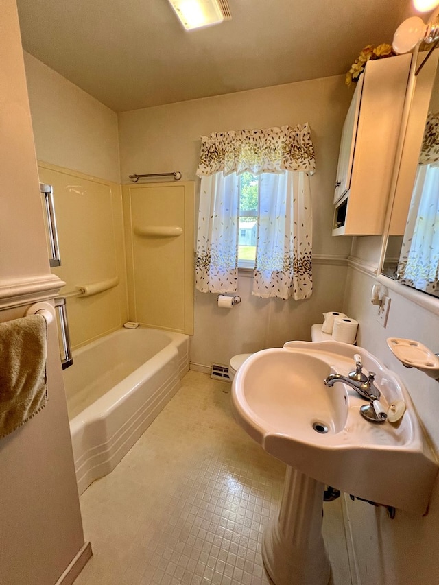 bathroom featuring toilet and shower / washtub combination