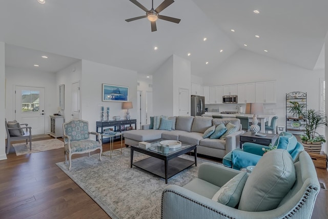 living room featuring dark hardwood / wood-style flooring, high vaulted ceiling, and ceiling fan