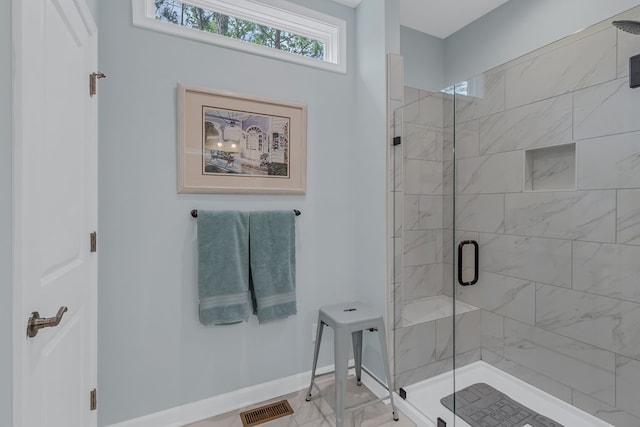 bathroom featuring a shower with door